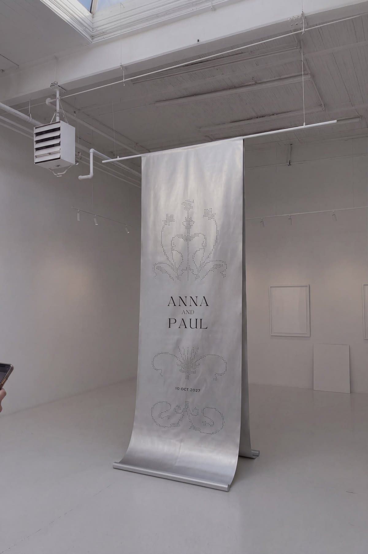 Anna and Paul large-format printed satin wedding banner, custom signage installation in a white gallery