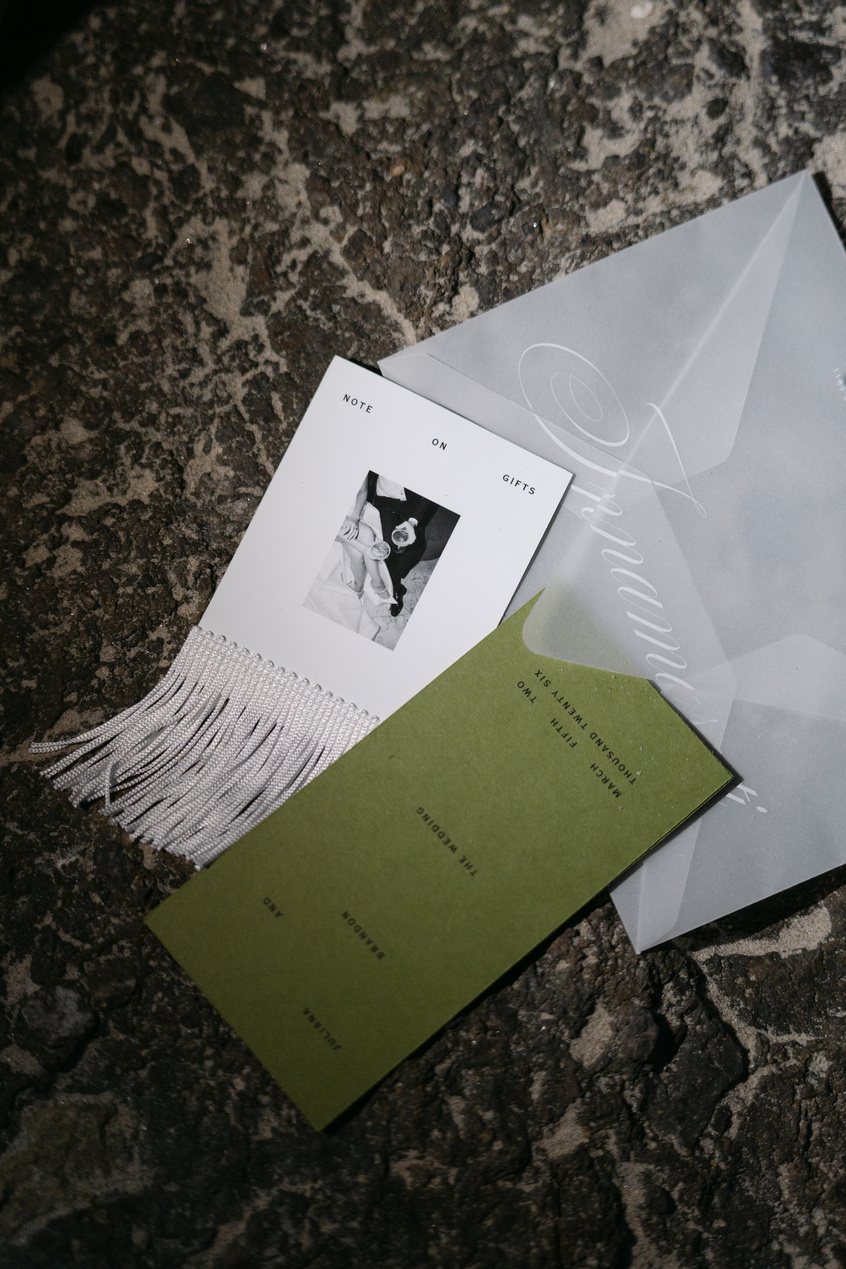 Editorial wedding invitation suite with green insert and vellum on marble