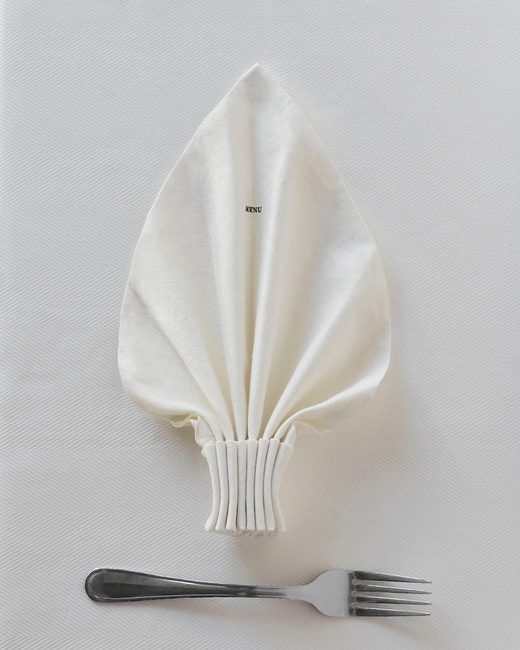 Editorial wedding tablescape, folded linen napkin and silver fork styled by UTWÖ Studio